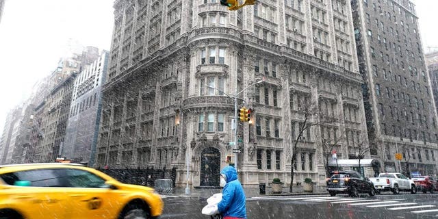 The Alwyn Court, a 12-story apartment building in midtown, is pictured as a delivery man drives in the snow/rain combination in New York on March 9, 2022.