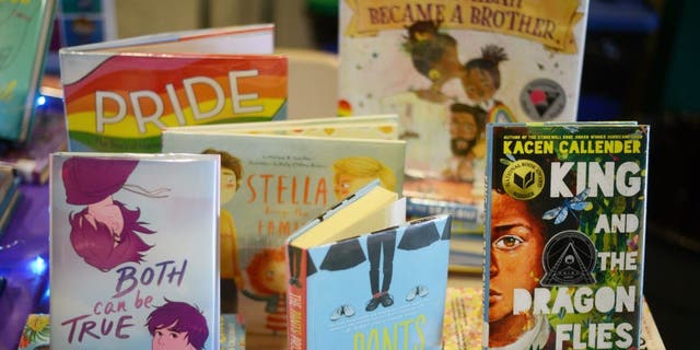 Children's books that are fighting for survival at public schools because of their LGBTQ content are displayed at the annual Pride Town Hall at Walter Johnson High School in Bethesda, Md., May 21, 2022.