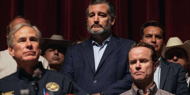 sen.  Ted Cruz, R-Texas, watches as Texas Governor Greg Abbott speaks during a press conference at Uvalde High School on May 25, 2022 in Uvalde, Texas.  
