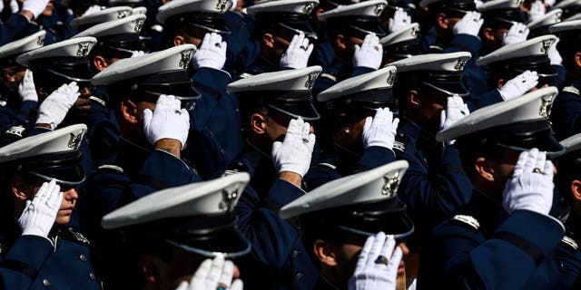 Air Force Academy cadets salute during the national anthem at Falcon Stadium for their graduation ceremony May 25, 2022, in Colorado Springs, Colo. 