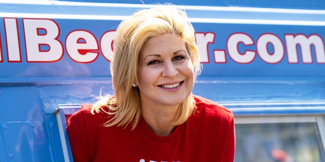 Republican candidate for U.S. Congress April Becker poses in the window of her campaign van, a converted ice cream truck, in Las Vegas, Nev.