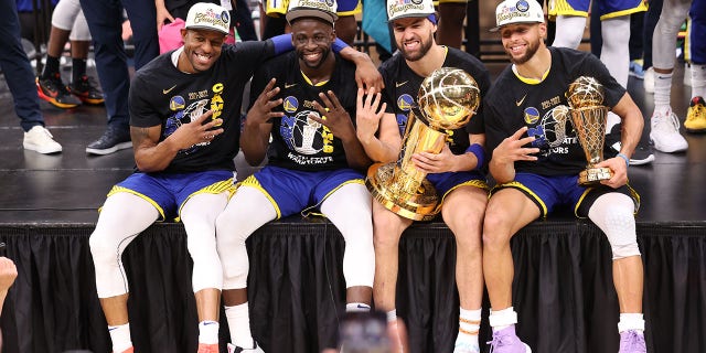 Andre Iguodala, Drummond Green, Klay Thompson and Stephen Curry of the Golden State Warriors pose for a photo with the Larry O'Brien Trophy and the Bill Russell NBA Finals MVP Award after Game 6 of the 2022 NBA Finals on June 16, Gardens in Boston on 2022 at TD.
