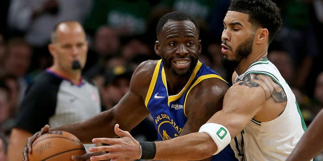 Jayson Tatum of the Celtics guards Draymond Green of the Golden State Warriors during the NBA Finals on June 16, 2022 in Boston.