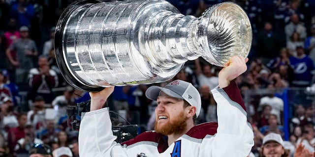 Colorado Avalanche center Nathan MacKinnon hoisting the Stanley Cup after Game 6 of the Stanley Cup Finals against the Tampa Bay Lightning June 26th, 2022, at Amalie Arena in Tampa, Fla.