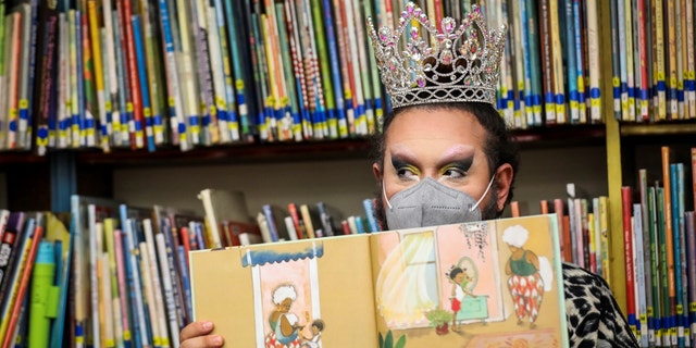 Drag queen Just JP reads stories to children during a "drag story hour" at Chelsea Public Library in Chelsea, Massachusetts, on June 25, 2022.