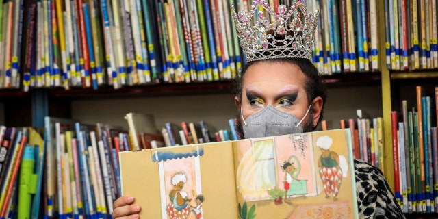 Drag queen Just JP reads stories to children during a Drag Story Hour at Chelsea Public Library in Chelsea, MA on June 25, 2022.