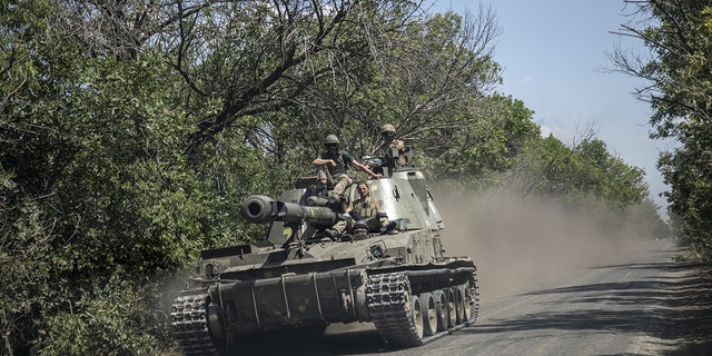 SIVERSK, DONETSK PROVINCE, UKRAINE, JULY 08: Ukrainian serviceman ride on top of a tank towards the battlefield nearby Siversk, Ukraine, July 08th, 2022. 