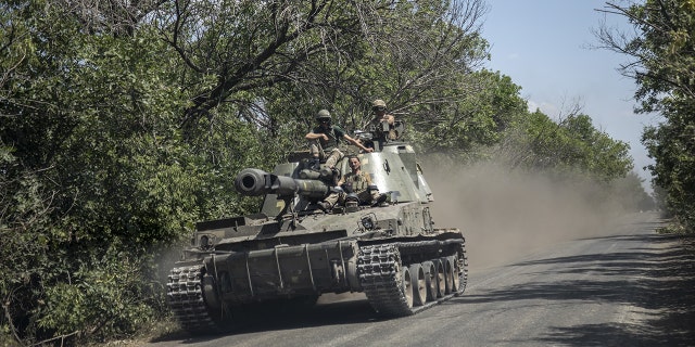 SIVERSK, DONETSK PROVINCE, UKRAINE, JULY 08: Ukrainian serviceman ride on top of a tank towards the battlefield nearby Siversk, Ukraine, July 08th, 2022. 