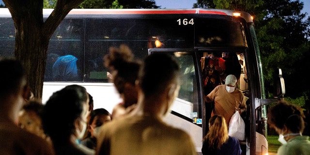 Migrants from Venezuela, who boarded a bus in Del Rio, Texas, disembark within view of the US Capitol in Washington, DC, on August 2, 2022.