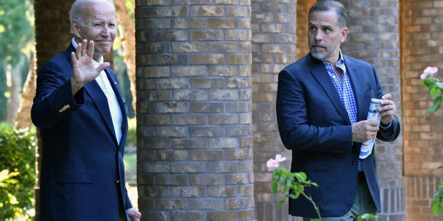 US President Joe Biden (L) waves alongside his son Hunter Biden after attending mass at Holy Spirit Catholic Church in Johns Island, South Carolina on August 13, 2022.