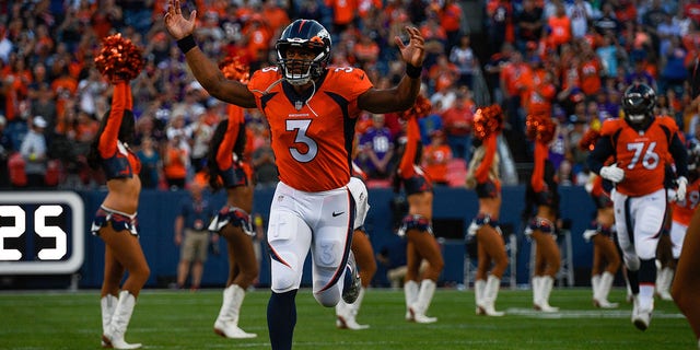 Quarterback Russell Wilson, #3 of the Denver Broncos, runs onto the field before a preseason game against the Minnesota Vikings at Empower Field at Mile High on August 27, 2022, in Denver. 