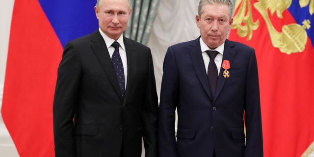 Russian President Vladimir Putin and Lukoil President Ravil Maganov pose during an awards ceremony in the Kremlin in Moscow, November 21, 2019.