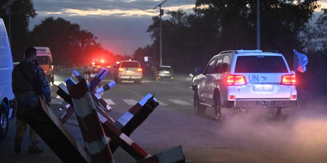 UN vehicles transport members of the International Atomic Energy Agency inspection mission after their visit to the Russian-held Zaporizhzhia nuclear power plant in southern Ukraine on Sept. 1, 2022.