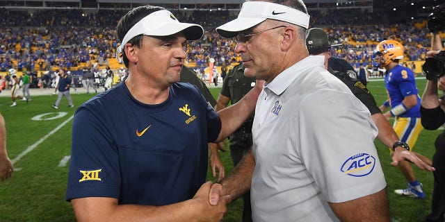 Pittsburgh Panthers head coach Pat Narduzzi shakes hands with West Virginia Mountaineers head coach Neal Brown at the conclusion of the game at Acrisure Stadium in Pittsburgh on Thursday, Sept. 1, 2022.