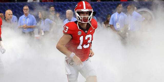 Georgia Bulldogs quarterback Stetson Bennett runs out of the tunnel before a game against the Oregon Ducks Sept. 3, 2022, at Mercedes-Benz Stadium in Atlanta.  