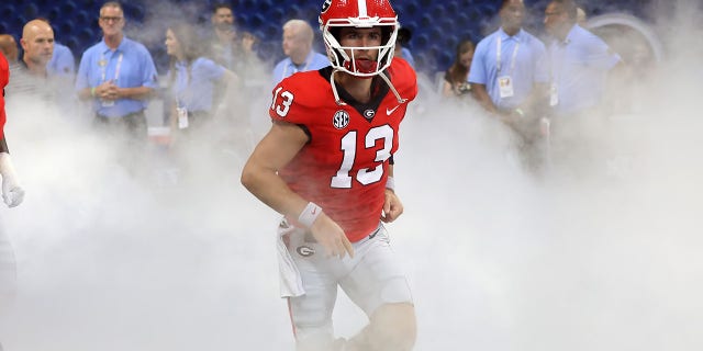 Georgia Bulldogs quarterback Stetson Bennett runs out of the tunnel before a game against the Oregon Ducks Sept. 3, 2022, at Mercedes-Benz Stadium in Atlanta.