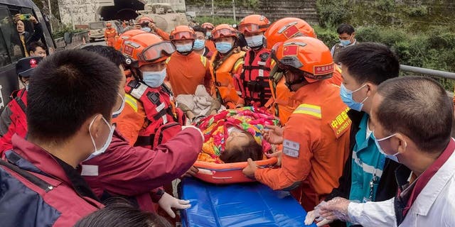 Rescuers carry injured people after a magnitude 6.6 earthquake in Luding county, Ganzi county, southwestern Sichuan province, China, on September 6, 2022.