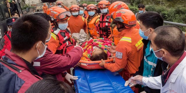 Rescuers carry injured people after a magnitude 6.6 earthquake in Luding county, Ganzi county, southwestern Sichuan province, China, on September 6, 2022.