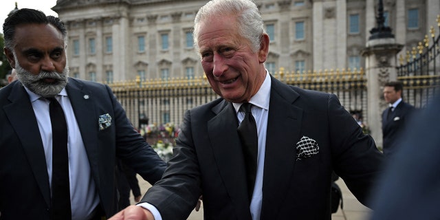Britain's King Charles III greets the members of the public in the crowd.