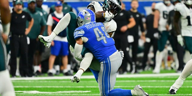 Detroit Lions linebacker Malcolm Rodriguez (44) knocks down Philadelphia Eagles running back Miles Sanders (26) during a game Sunday, Sept. 11, 2022 at Ford Field in Detroit.