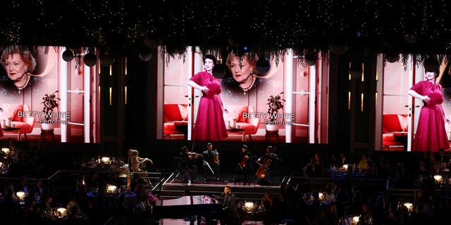 Late actress Betty White is seen onscreen during an "In Memoriam" segment performed by US singer-songwriter John Legend onstage during the 74th Emmy Awards at the Microsoft Theater in Los Angeles, California, on September 12, 2022.