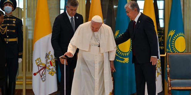 Pope Francis is welcomed by Kazakh President Kassym-Jomart Tokayev upon his arrival at Nur-Sultan International Airport in Nur-Sultan on Sept. 13, 2022. 