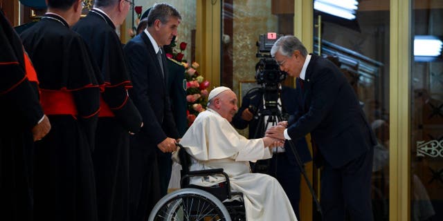 Pope Francis is welcomed by Kazakhstan's President Kasim-Jomart Tokayev upon arrival at Nur-Sultan International Airport, September 13, 2022.