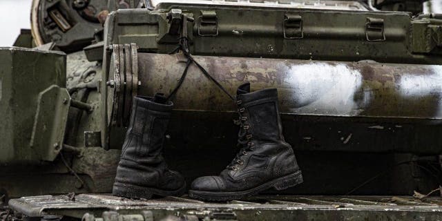 A damaged Russian military vehicle and military boots are seen after Russian Forces withdrawal as Russia-Ukraine war continues in Izyum, Kharkiv Oblast, Ukraine on Sept. 14, 2022.