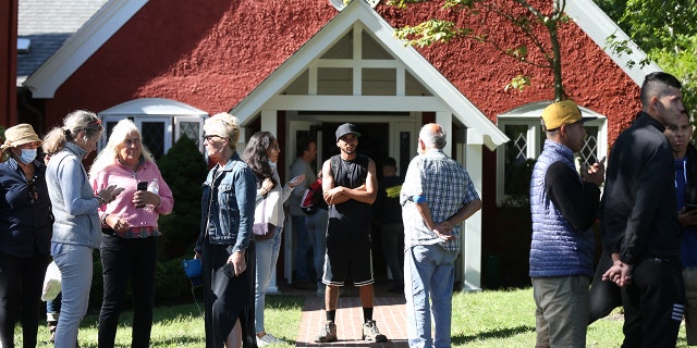 Volunteers mingle outside of St. Andrews Episcopal Church. Two planes of migrants from Venezuela arrived suddenly Wednesday night on Martha's Vineyard.