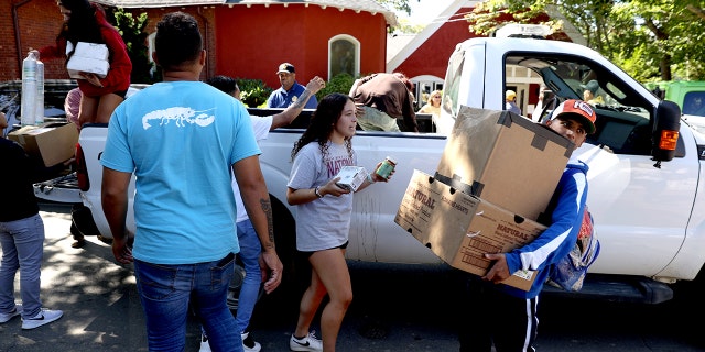 Martha's Vineyard, MA - September 15: Students from the Marthas Vineyard Regional High School AP Spanish class help deliver food to St Andrews Episcopal Church. Two planes of migrants from Venezuela arrived suddenly Wednesday night on Martha's Vineyard. The students served as translators for the migrants.