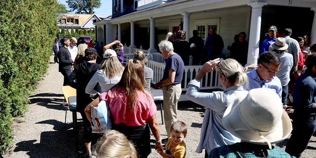 Residents of Martha's Vineyard line up in front of St. Andrews Parish House to donate food to recently arrived immigrants on September 15, 2022.
