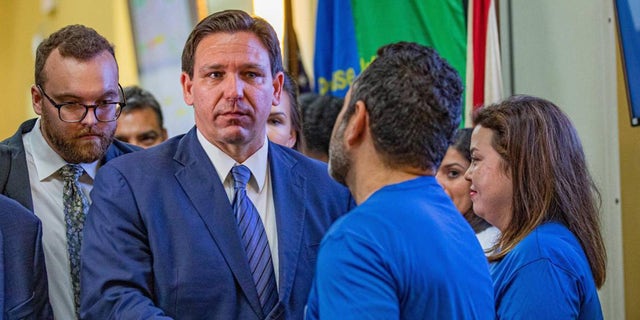 Florida Governor Ron DeSantis shakes hands with a member of the Florida Department of Transportation as he leaves a press conference on toll relief at the Florida Department of Transportation District 6 headquarters in Miami on Wednesday, September 7, 2022.