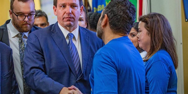 Florida Gov. Ron DeSantis shakes hands with a member of the Florida Department of Transportation while leaving a press conference regarding toll relief at the Florida Department of Transportation District 6 Headquarters in Miami on Wednesday, Sept. 7, 2022.