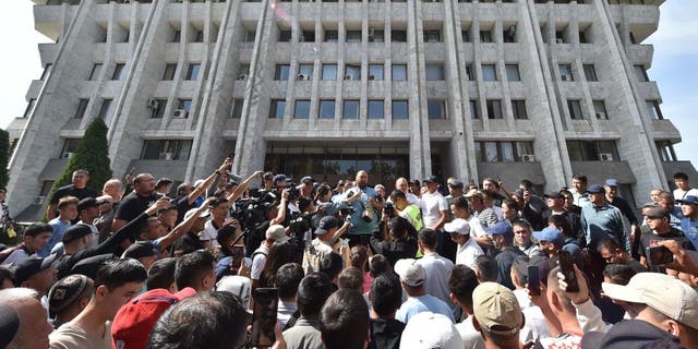 Protesters rally near the Kyrgyz parliament in Bishkek to demand authorities support residents of Kyrgyzstan's southern Batken province following border clashes with Tajik troops, Sept. 16, 2022.