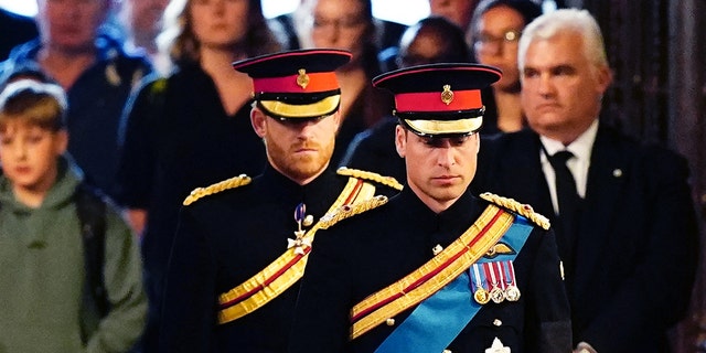 At the Queen's vigil, her two grandsons Prince Harry and Prince William wore noticeably different uniforms, and only one had the "ER" initials on his suit.