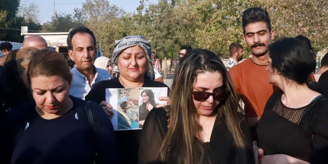 Iranian Kurds participate in a march in a park in the Iraq Kurdish city of Sulaimaniya on Sept. 19, 2022, against the killing of Mahsa Amini, a woman in Iran who died after being arrested by the Islamic republic's "morality police". (SHWAN MOHAMMED/AFP via Getty Images)