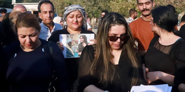 Iranian Kurds participate in a march in a park in the Iraq Kurdish city of Sulaimaniya on Sept. 19, 2022, against the killing of Mahsa Amini, a woman in Iran who died after being arrested by the Islamic republic's 