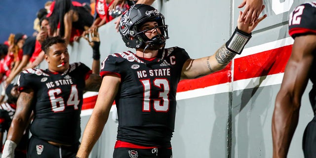 Devin Leary (13) of the North Carolina State Wolfpack celebrates with fans after a game against the Texas Tech Red Raiders Sept. 17, 2022, at Carter-Finley Stadium in Raleigh, N.C.