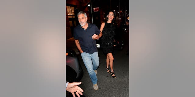 The couple held hands while leaving dinner 