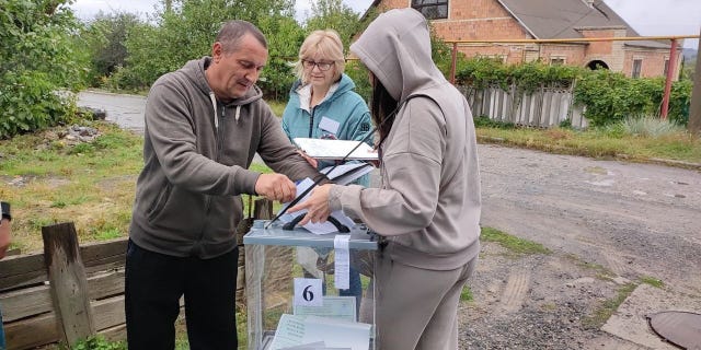 Residents cast their votes in controversial referendums in the city of Dokuchaievsk, Donetsk Oblast, Ukraine on Sept. 23, 2022.