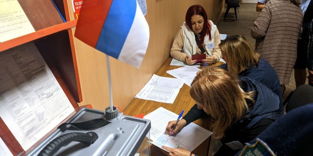 Residents cast their votes in controversial referendums in the city of Dokuchaievsk, Donetsk Oblast, Ukraine on Sept. 23, 2022.