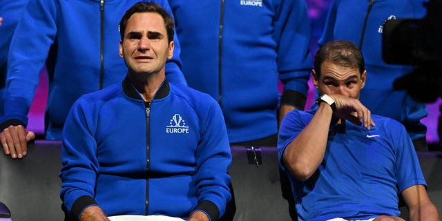 Switzerland's Roger Federer (L) sheds a tear after playing his final match, a doubles with Spain's Rafael Nadal (R) of Team Europe against USA's Jack Sock and USA's Frances Tiafoe of Team World in the 2022 Laver Cup at the O2 Arena in London, early on Sept.  24, 2022.