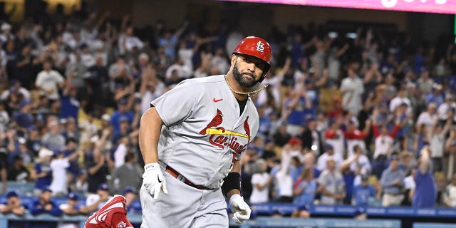 Albert Pujols of the St. Louis Cardinals watches his two-run home run, the 699th of his career, off starting pitcher Andrew Heaney of the Los Angeles Dodgers in the third inning at Dodger Stadium in Los Angeles Friday, Sept. 23, 2022.