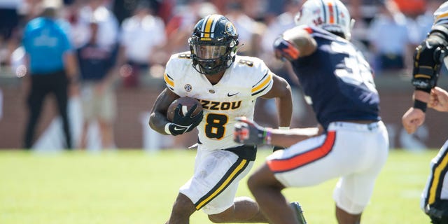Running back Nathaniel Peat #8 of the Missouri Tigers looks to run the ball by defensive back Greg McConico Jr. #38 of the Auburn Tigers during the second half of play at Jordan-Hare Stadium on Sept. 24, 2022 in Auburn, Alabama. 
