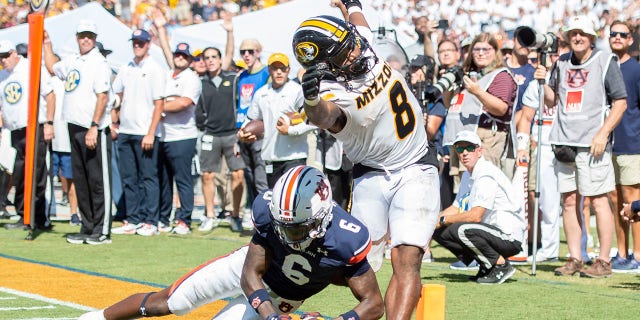 Linebacker Eugene Asante #9 of the Auburn Tigers chases after the loose ball as running back Nathaniel Peat #8 of the Missouri Tigers fumbles during the overtime period at Jordan-Hare Stadium on Sept. 24, 2022 in Auburn, Alabama.