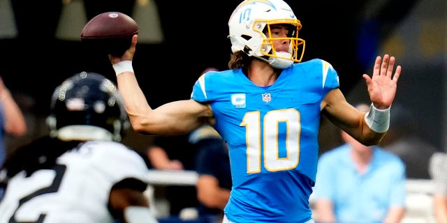 Quarterback Justin Herbert, #10 of the Los Angeles Chargers, passes against the Jacksonville Jaguars in the first half of an NFL football game at SoFi Stadium in Inglewood, California on Sunday, September 25, 2022.