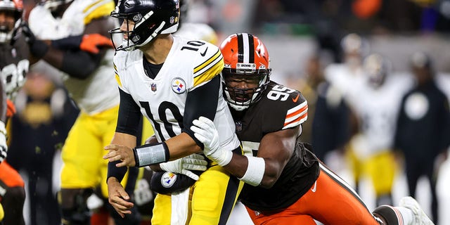 Cleveland Browns defensive end Myles Garrett (95) hits Pttsburgh Steelers quarterback Mitch Trubisky (10) after Trubisky threw a pass during the second quarter of the National Football League game between the Pittsburgh Steelers and Cleveland Browns on September 22, 2022, at FirstEnergy Stadium in Cleveland, OH. 