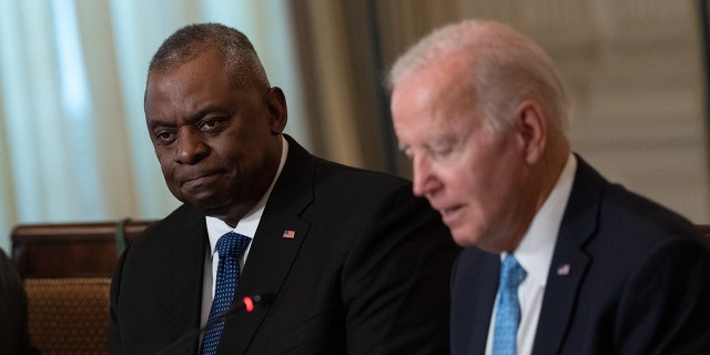 Secretary fo Defense Lloyd Austin, left, as President Biden speaks during a meeting of the White House Competition Council in the State Dining Room in Washington, D.C., on Monday, Sept. 26, 2022. 