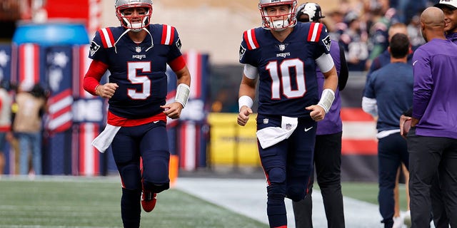 New England Patriots quarterbacks Brian Hoyer, left, and Mac Jones before the Baltimore Ravens game on Sept. 25, 2022, at Gillette Stadium in Foxborough, Massachusetts.