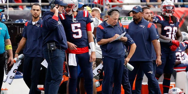 Patriots quarterbacks coach Joe Judge and quarterback Brian Hoyer confer as head coach Bill Belichick makes notes during the Baltimore Ravens game on Sept. 25, 2022, at Gillette Stadium in Foxborough, Massachusetts.